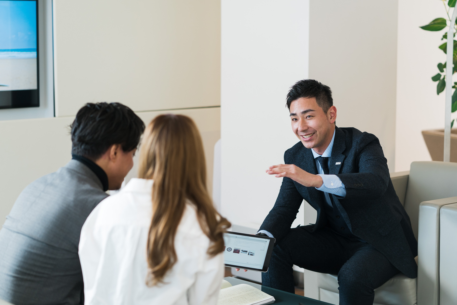 Couple Chatting with a Car Salesperson